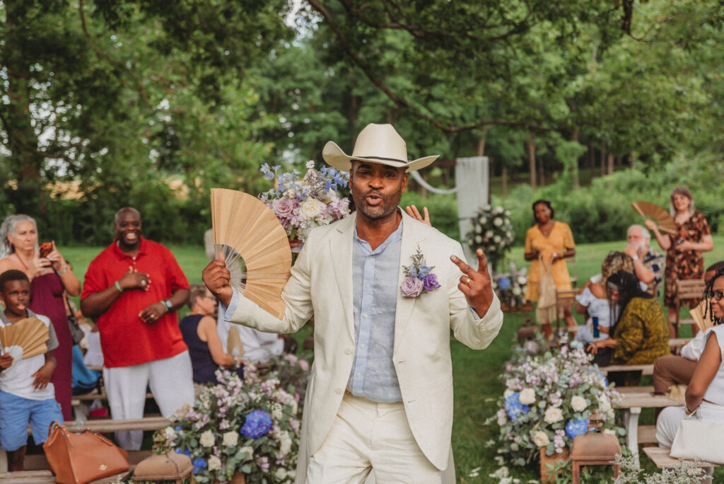 Groom posing in cowboy hat during Kennedy Estate wedding