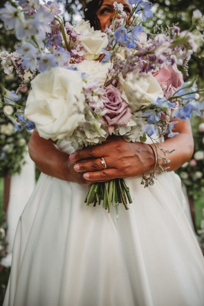 Close-up of purple, blue, ivory and white wedding bouquet