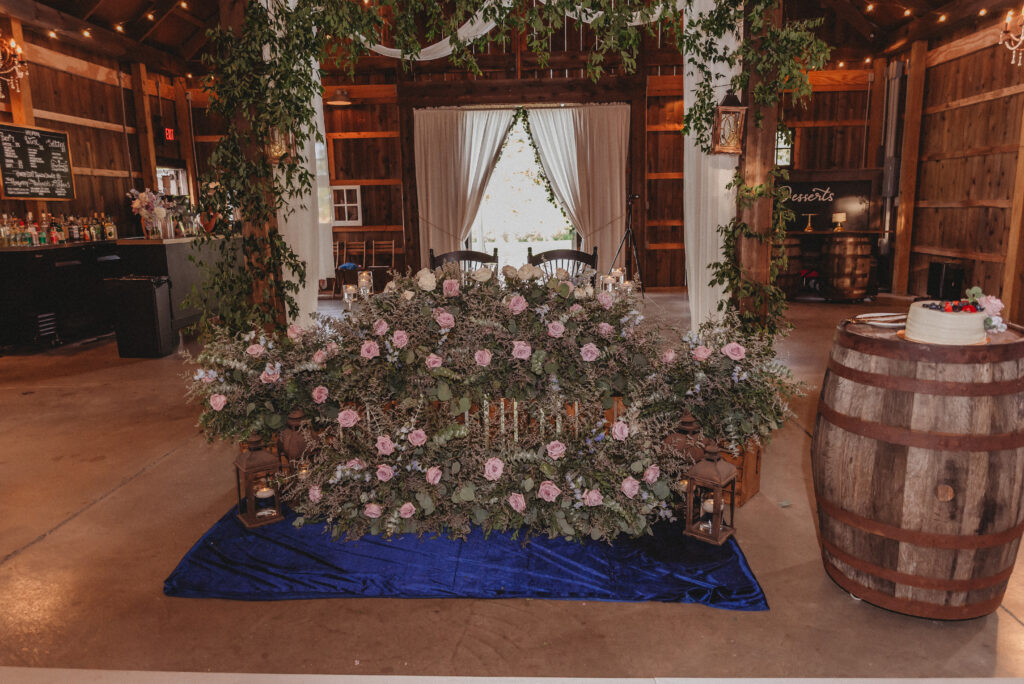 Rustic wedding reception at Kennedy Estate with purple and blue floral details