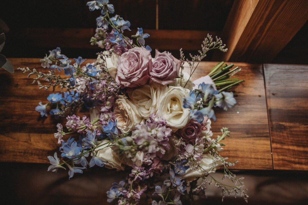 Close-up of purple, blue, ivory and white wedding bouquet